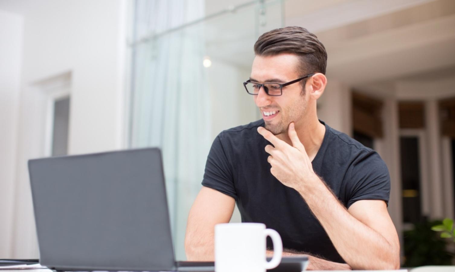 Modern office workspace with multiple monitors showing system management dashboards